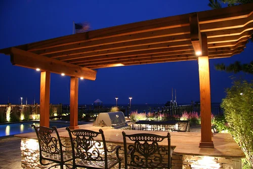 Waterfront path and dock lighting with warm low voltage fixtures near a Charleston marsh home at twilight