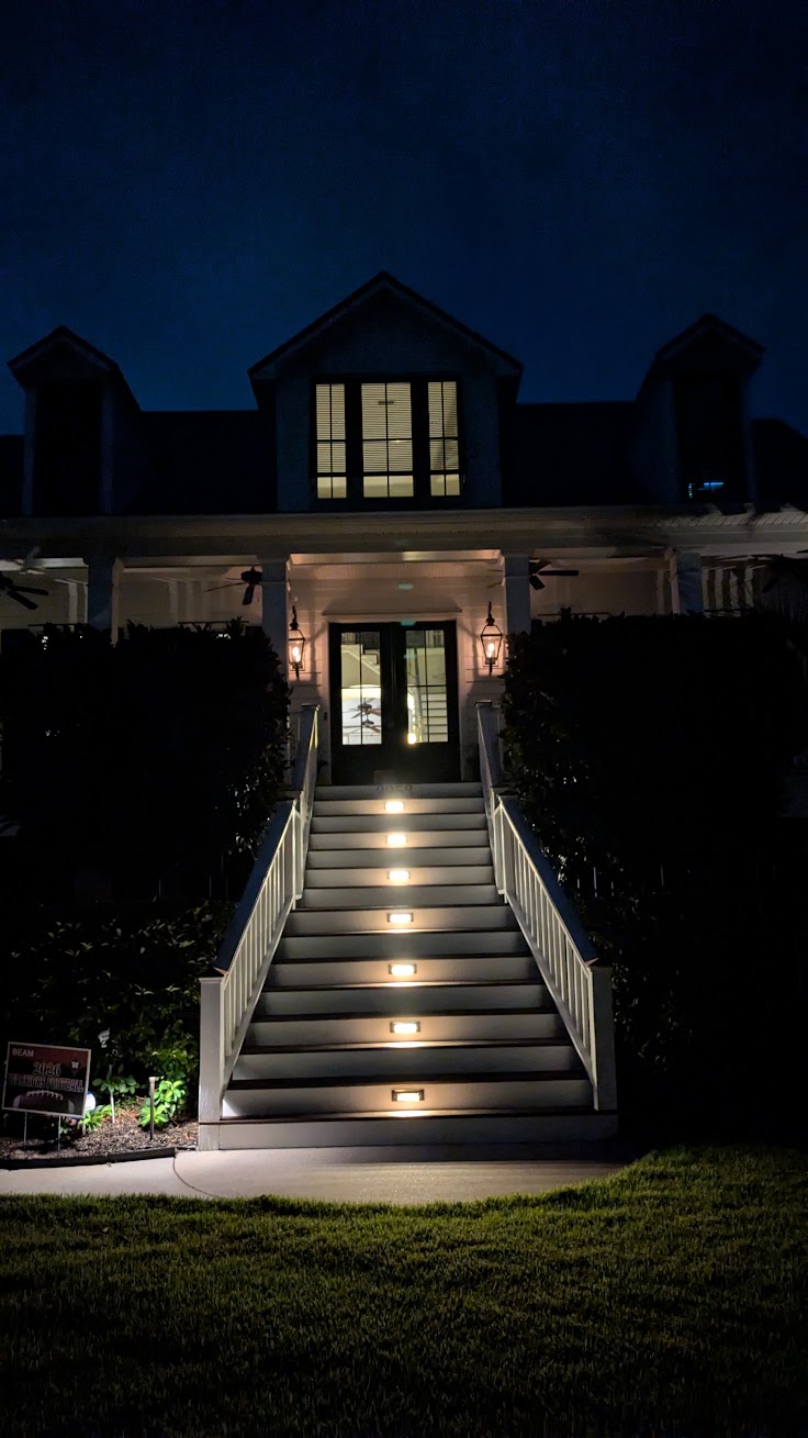 Warm low voltage stair lights installed along a Mount Pleasant Hamlin Plantation outdoor stairway with islander-style steps