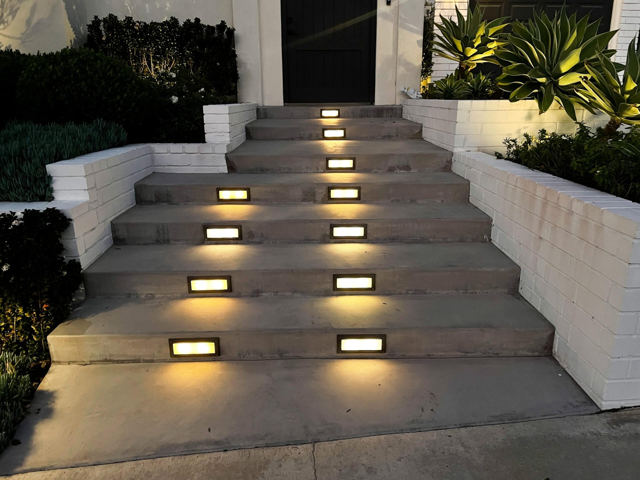 Integrated stair lighting on front entry steps with warm rectangular low voltage lights in Charleston SC